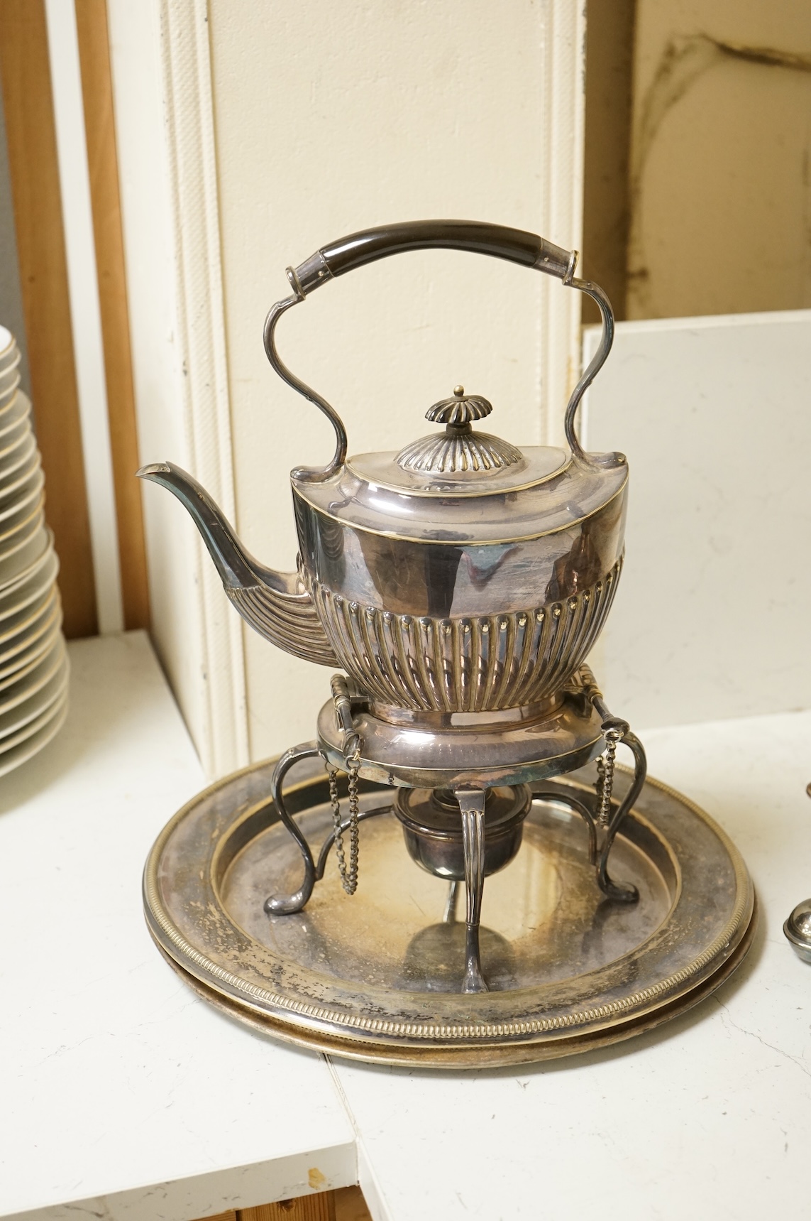 A Victorian silver plated urn, height 42cm, a silver plated spirit kettle and two circular dishes.